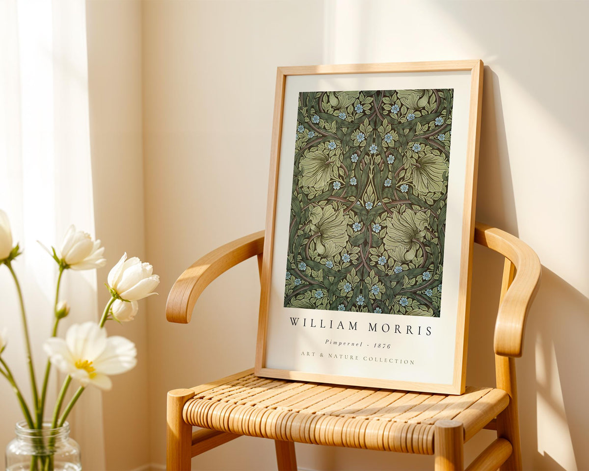 A framed print of William Morris's "Primpernel 1826" is displayed on a wooden chair, with a vase of white flowers to the left.