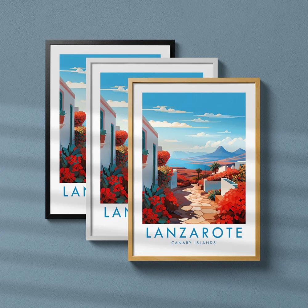 The image is a framed poster of a scenic view of Lanzarote, the Canary Islands. The poster features a picturesque landscape with a winding path, colorful flowers, and a backdrop of mountains and a blue sky.