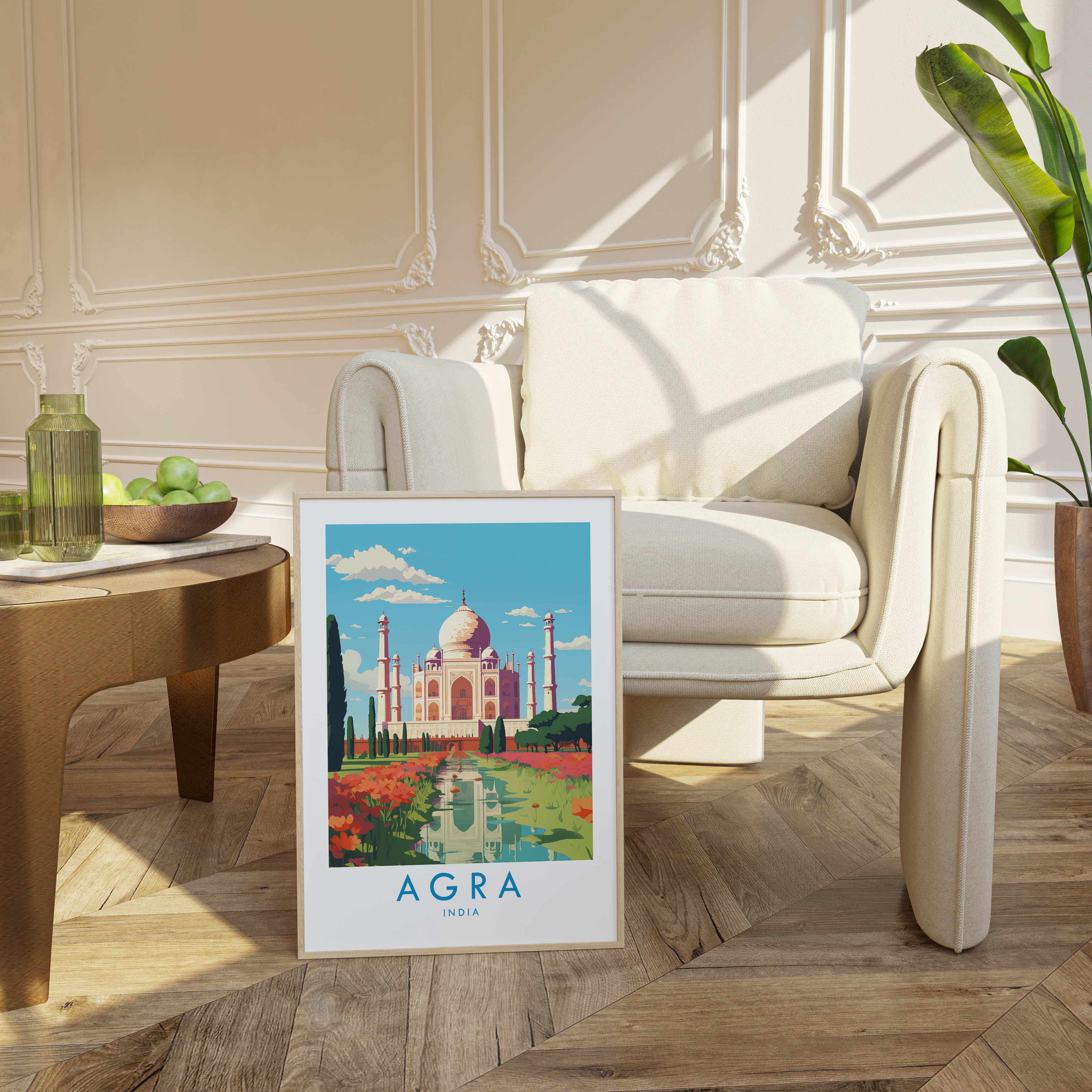 a poster of the Taj Mahal in Agra, India, placed on a wooden floor in a living room setting with a white sofa and a potted plant.
